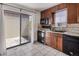 Functional kitchen with dark cabinetry, matching appliances, and access to a private outdoor space at 9338 W Utah Pl, Lakewood, CO 80232