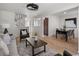 Inviting living room with modern decor, wood floors, and plenty of natural light at 9338 W Utah Pl, Lakewood, CO 80232
