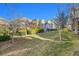 Backyard featuring a deck, green lawn, and stone home exterior at 14032 E Chenango Dr, Aurora, CO 80015