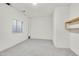 Basement room with neutral carpet, window and a closet shelf at 14032 E Chenango Dr, Aurora, CO 80015