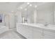All-white bathroom features double sinks, vanity storage, and gold shower door at 14032 E Chenango Dr, Aurora, CO 80015