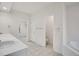 Bright bathroom featuring double sinks, tiled flooring, and gold hardware accents at 14032 E Chenango Dr, Aurora, CO 80015