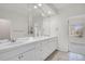 Bathroom featuring double sinks, large vanity and a large window looking out onto the street at 14032 E Chenango Dr, Aurora, CO 80015