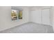 Bright bedroom with large window, neutral carpet, and built in closet at 14032 E Chenango Dr, Aurora, CO 80015