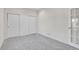 Bedroom with neutral carpet, large closet with sliding doors and a large window at 14032 E Chenango Dr, Aurora, CO 80015