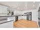 Updated kitchen with stainless appliances, white cabinets, and ample counter space at 14032 E Chenango Dr, Aurora, CO 80015