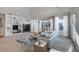 Bright living room featuring neutral colors, fireplace, built in shelving and large windows at 14032 E Chenango Dr, Aurora, CO 80015