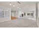 Spacious living room with high ceilings, fireplace, built-ins, large windows, and neutral carpet at 14032 E Chenango Dr, Aurora, CO 80015