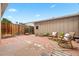 Cozy backyard features a brick patio, wooden fence, and comfortable rocking chairs at 10310 E Jewell Ave # 57, Aurora, CO 80247
