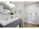 Modern bathroom with double sinks, gray vanity, and a separate shower area at 10310 E Jewell Ave # 57, Aurora, CO 80247
