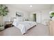 Calming bedroom with neutral tones, white bedding, and a seating area at 10310 E Jewell Ave # 57, Aurora, CO 80247