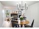 Bright dining room with black chandelier, modern furniture, and wood-burning fireplace at 10310 E Jewell Ave # 57, Aurora, CO 80247