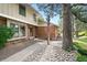 Charming home exterior with brick accents, well-kept landscaping, and inviting entryway at 10310 E Jewell Ave # 57, Aurora, CO 80247