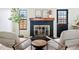Cozy living area with a brick fireplace, stylish decor, and comfortable seating at 10310 E Jewell Ave # 57, Aurora, CO 80247