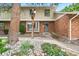 Inviting brick townhouse featuring a well-maintained garden and charming entryway at 10310 E Jewell Ave # 57, Aurora, CO 80247
