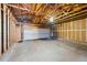 Spacious garage with exposed wooden beams and plenty of room for parking and storage at 10310 E Jewell Ave # 57, Aurora, CO 80247