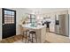 Charming kitchen with stainless steel appliances, breakfast bar, and access to backyard at 10310 E Jewell Ave # 57, Aurora, CO 80247