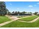 Well-maintained community tennis court surrounded by lush greenery and pathways at 10310 E Jewell Ave # 57, Aurora, CO 80247