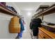 Large walk-in closet with double hanging rods and shelving at 10150 E Virginia Ave # 2-205, Denver, CO 80247