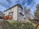 View of the home's exterior showing a raised deck, grassy yard, and a beautiful bay window feature at 11262 Winona Ct, Westminster, CO 80031