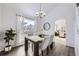 Elegant dining room with modern table, chairs, chandelier, and window views at 11262 Winona Ct, Westminster, CO 80031