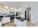 Bright kitchen featuring stainless steel appliances, island, and white cabinetry at 11262 Winona Ct, Westminster, CO 80031