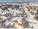 Aerial view of house and neighborhood in snowy landscape at 1585 Old Antlers, Monument, CO 80132