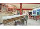 Stone-finished basement bar with wine rack and seating at 1585 Old Antlers, Monument, CO 80132