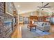 Spacious living room with stone fireplace and hardwood floors at 1585 Old Antlers, Monument, CO 80132