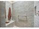 Walk-in shower with built-in seat and tiled walls at 1585 Old Antlers, Monument, CO 80132