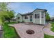 Backyard with patio area, grass, wooden fence, and surrounding greenery at 5350 S Quail Way, Littleton, CO 80127