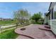 Backyard with brick patio, grass, and view of open space at 5350 S Quail Way, Littleton, CO 80127