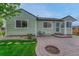 Inviting backyard patio with a fire pit, green grass, and low-maintenance yard at 5350 S Quail Way, Littleton, CO 80127
