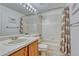 Bright bathroom featuring a vanity with a sink and a shower-tub combination at 5350 S Quail Way, Littleton, CO 80127