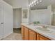Bright bathroom with double sinks, wood cabinets, and a large mirror at 5350 S Quail Way, Littleton, CO 80127