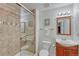 Bathroom featuring tiled shower with glass door, vanity, toilet, mirror, and lighting at 5350 S Quail Way, Littleton, CO 80127