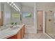 Bathroom featuring double sinks, a bathtub, and a separate glass-enclosed shower at 5350 S Quail Way, Littleton, CO 80127