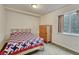Cozy bedroom featuring a bed, dresser, and window with natural light at 5350 S Quail Way, Littleton, CO 80127