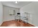 Well-lit bedroom with desk, office chair, glass shelving, hardwood floors and large window at 5350 S Quail Way, Littleton, CO 80127