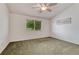 Bright bedroom featuring neutral walls and carpet, and a window offering outdoor views at 5350 S Quail Way, Littleton, CO 80127