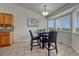 Cozy dining area featuring tile floors, a modern pendant light, and a large bay window at 5350 S Quail Way, Littleton, CO 80127