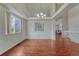 Elegant dining room featuring coffered ceilings, a modern chandelier, and gleaming hardwood floors at 5350 S Quail Way, Littleton, CO 80127