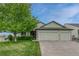 Charming green home featuring a lush front yard and a convenient three-car garage at 5350 S Quail Way, Littleton, CO 80127