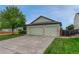 Exterior view showcasing a spacious three-car garage with a concrete driveway and green lawn at 5350 S Quail Way, Littleton, CO 80127