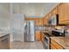Modern kitchen featuring stainless steel appliances, stone countertops and wood cabinets at 5350 S Quail Way, Littleton, CO 80127