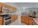Spacious kitchen with wood cabinets, stainless steel appliances, and granite countertops at 5350 S Quail Way, Littleton, CO 80127
