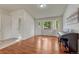 Bright living room featuring wood floors, a large window, and a stylish front door at 5350 S Quail Way, Littleton, CO 80127