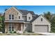 Inviting two-story home with stone accents, covered porch, and attached two car garage at 6299 Cristobal Pt, Parker, CO 80134