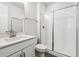 Clean bathroom with single vanity, shower/tub combo and white tile at 24955 E 41St Ave, Aurora, CO 80019