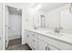 Double vanity bathroom with white cabinets and a view into another bathroom at 24955 E 41St Ave, Aurora, CO 80019